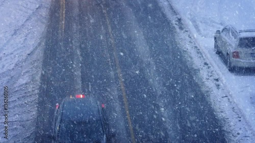 Cars And Trucks Passing In Blizzard