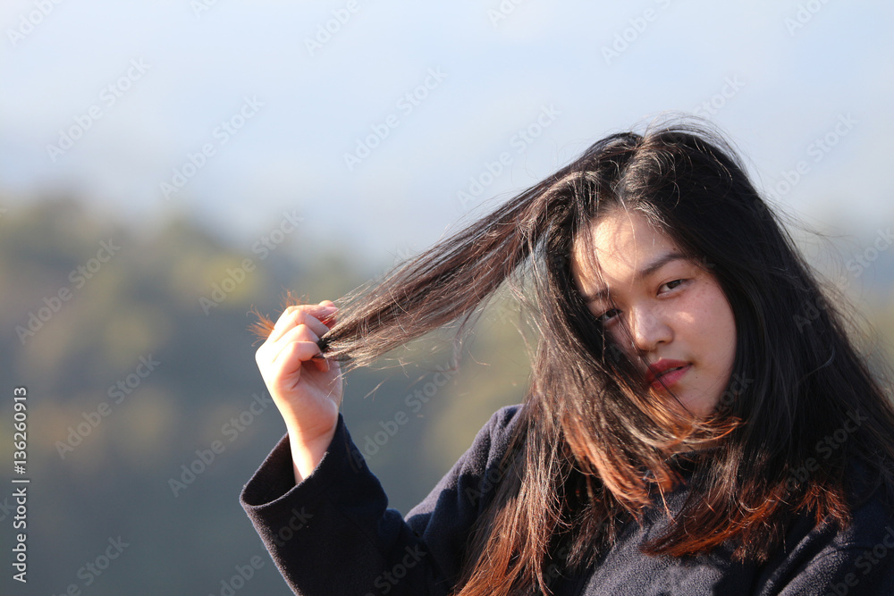 Portrait of women or girl looking and grab her hair with natural background Portrait of women or girl looking and grab her hair with natural background