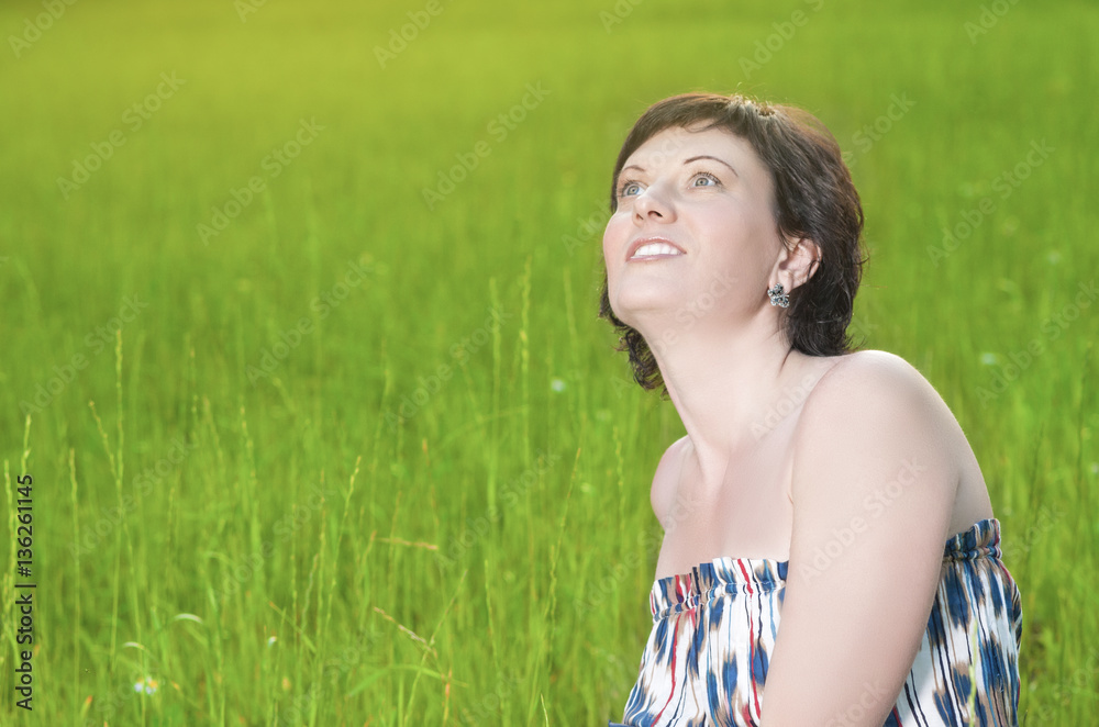 Portrait of Smiling Caucasian Brunette Woman Posing Outdoors on Grass
