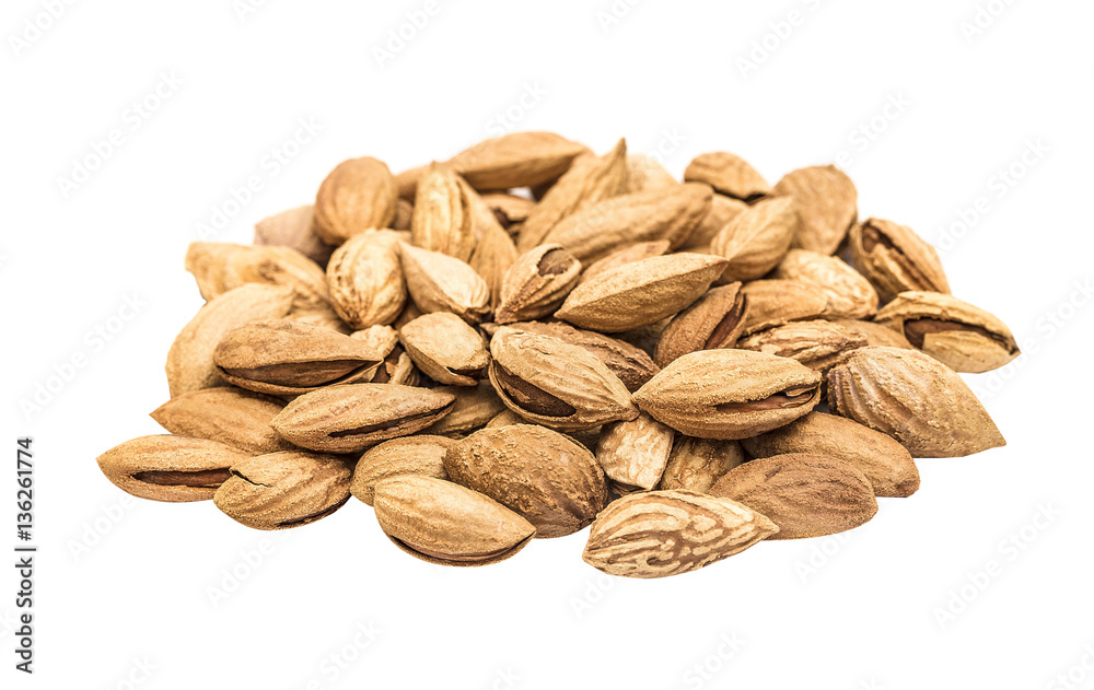 Obraz premium Heap almond nut closeup with shell on white, isolated.