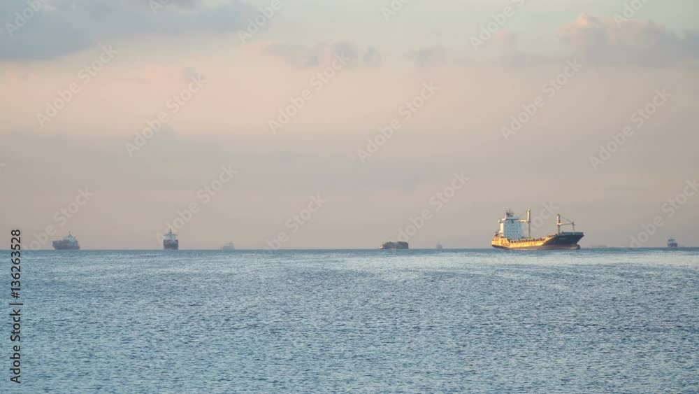 Cargo ships in the Bay of Manila. Large container ship in the sea, blue sky and clouds. 4K video. Philippines, Manila. Cargo ships in the Bay of Manila. Large container ship in the sea, blue sky and clouds. 4K video. Philippines, Manila.