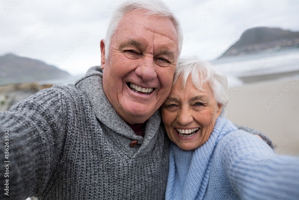 Portrait of senior couple standing on the beach