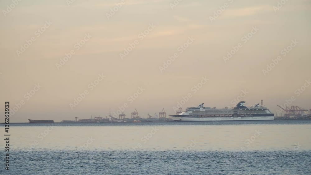 Cruise ship sailing from port at sunset. Beautiful white giant luxury cruise ship in a blue water sea, ocean. Luxury cruise ship sailing floating in Manila bay. 4K video, Philippines. Cruise ship sailing from port at sunset. Beautiful white giant luxury cruise ship in a blue water sea, ocean. Luxury cruise ship sailing floating in Manila bay. 4K video, Philippines.