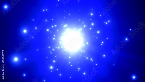 Bright light particles emitted against a blue background..