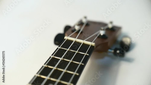 Closeup ukulele guitar tracking from camera on the slider.