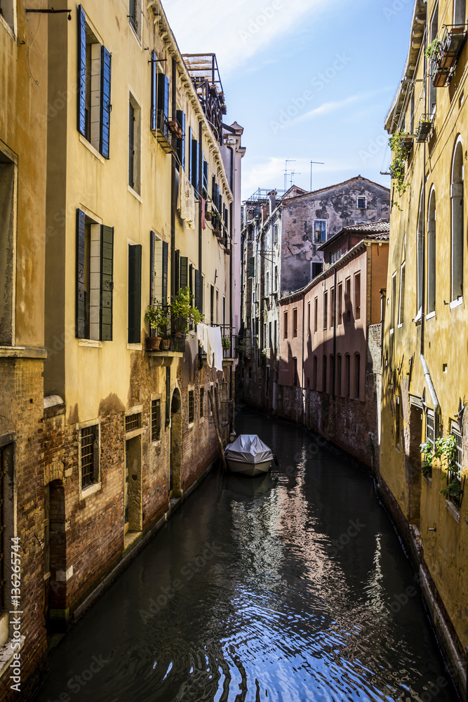 medieval architecture, houses, bridges, squares and boats on the canal-streets of Venice, Italy