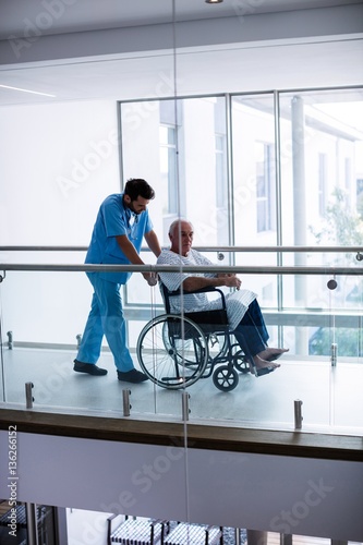 Male doctor interacting with senior patient