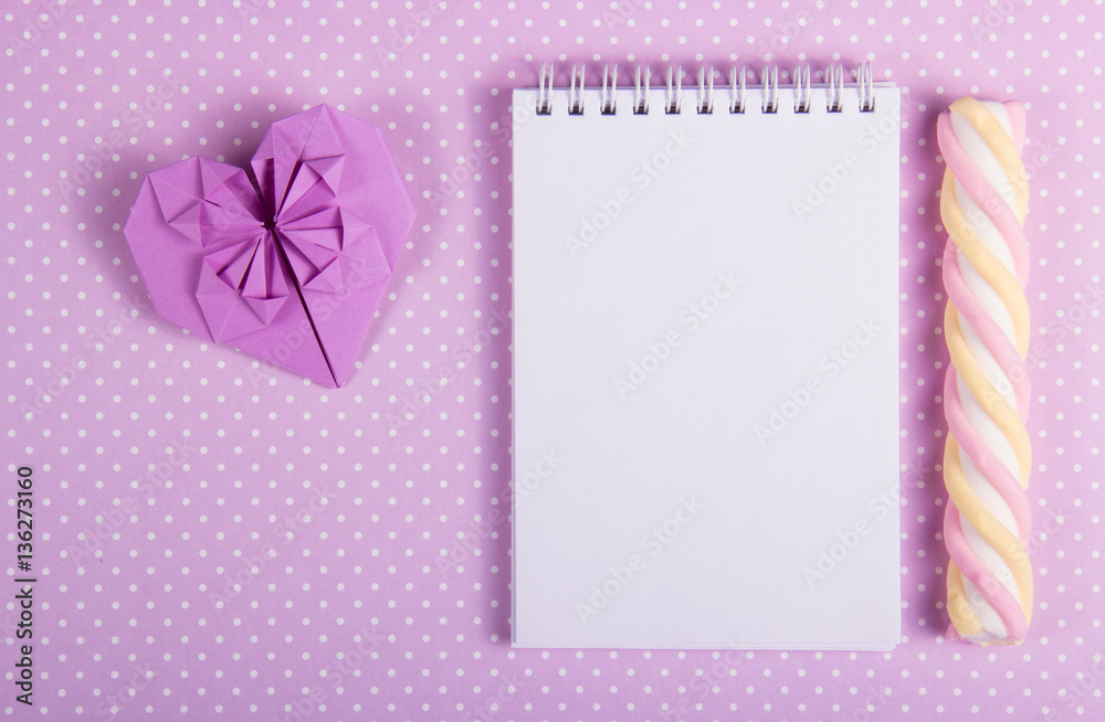 Valentine origami open notebook with a blank page and stick marshmallows on a background of polka dots. St. Valentine's Day. Copy spase Valentine origami open notebook with a blank page and stick marshmallows on a background of polka dots. St. Valentine's Day. Copy spase