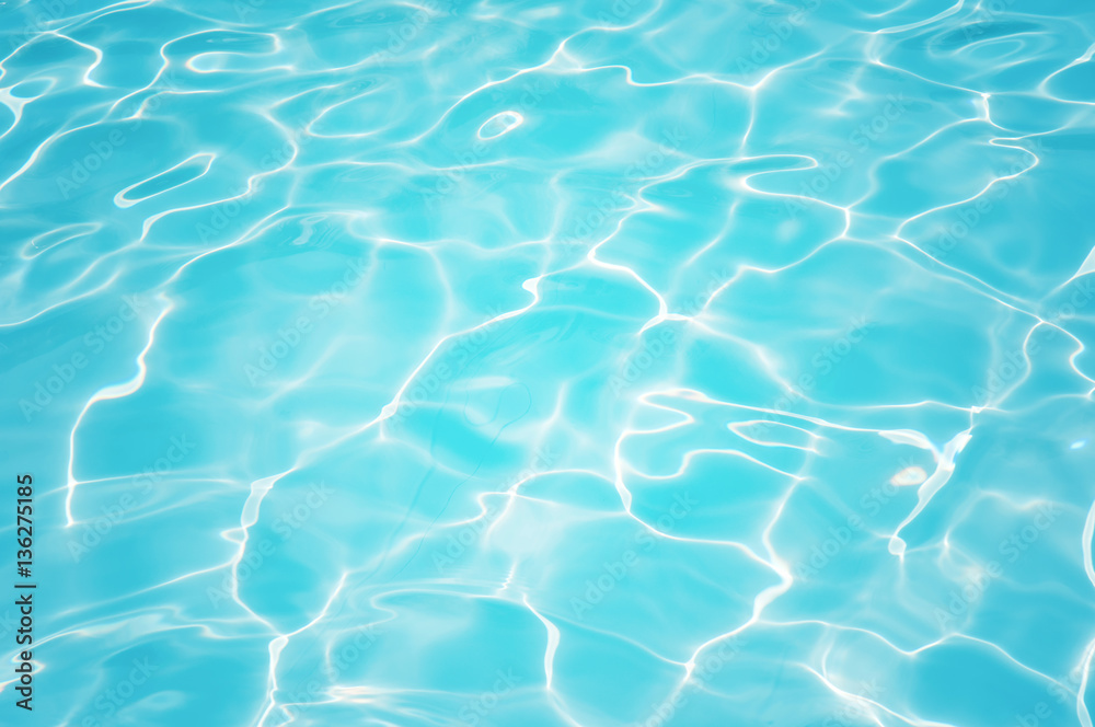 Beautiful ripple water surface with sun reflection in swimming pool Beautiful ripple water surface with sun reflection in swimming pool