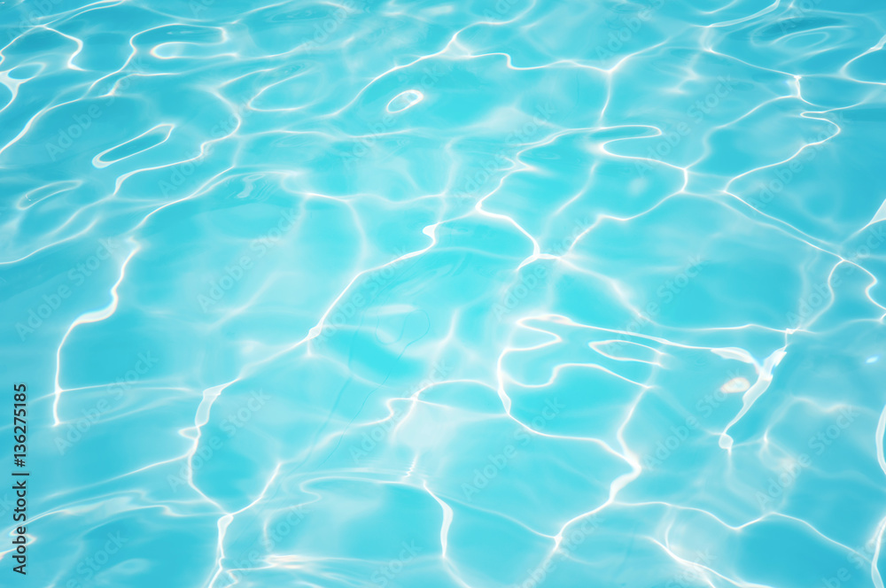 Beautiful ripple water surface with sun reflection in swimming pool