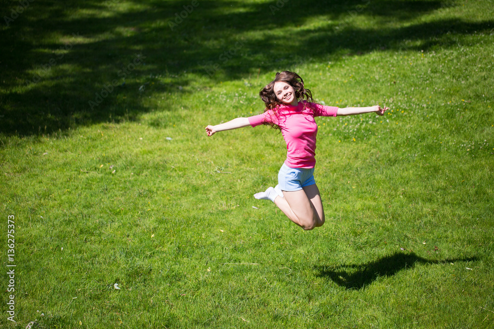 Young beautiful woman jumping in the park. Young beautiful woman jumping in the park.