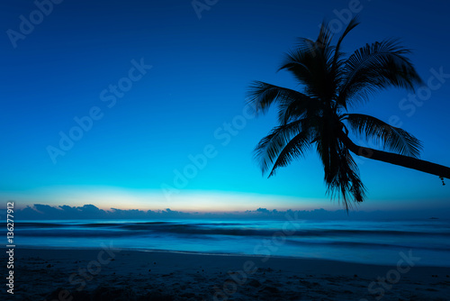 Sunrise at the sandy beach with blue sky