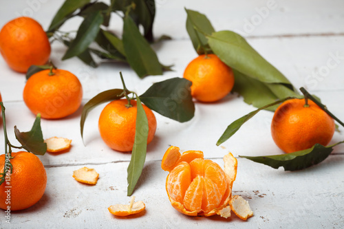 mandarins with leaves on white woodwn background