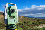 Modern surveyor equipment, theodolite or tacheometer  used in surveying and building construction for precise measurement. Total station outdoor at construction site. Copy space.