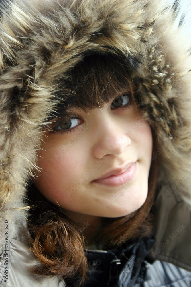 Beautiful young woman in fur head cloth looking at camera Beautiful young woman in fur head cloth looking at camera