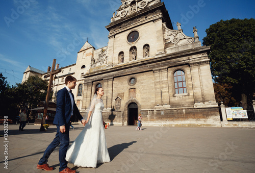 young couple passes by architectural monument