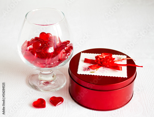 romantic still life with glass and hearts