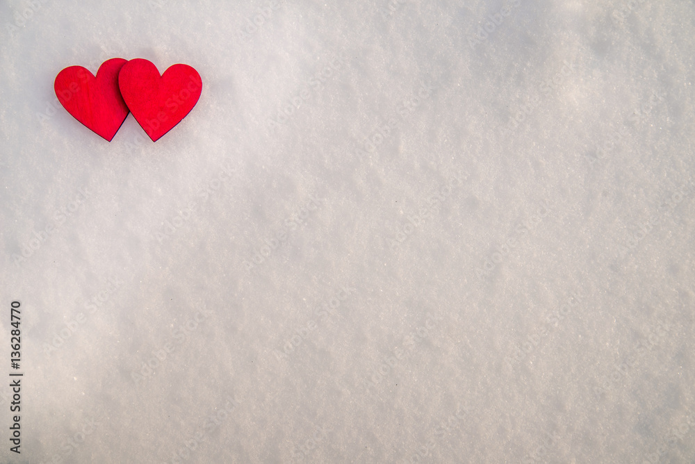 Two red hearts lie on the snow Two red hearts lie on the snow