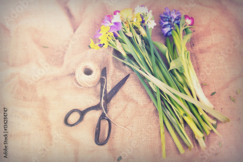 Spring flower arrangement against a rustic background