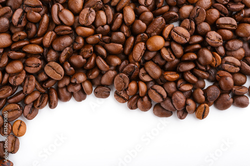 roasted coffee beans isolated in white background. Roasted coffee beans background close up. Coffee beans pile from top on white background with copy space for text. Good morning. © stas_malyarevsky