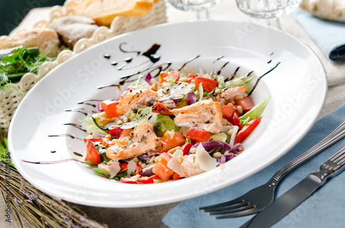 salad with fried salmon, pine nuts and parmesan