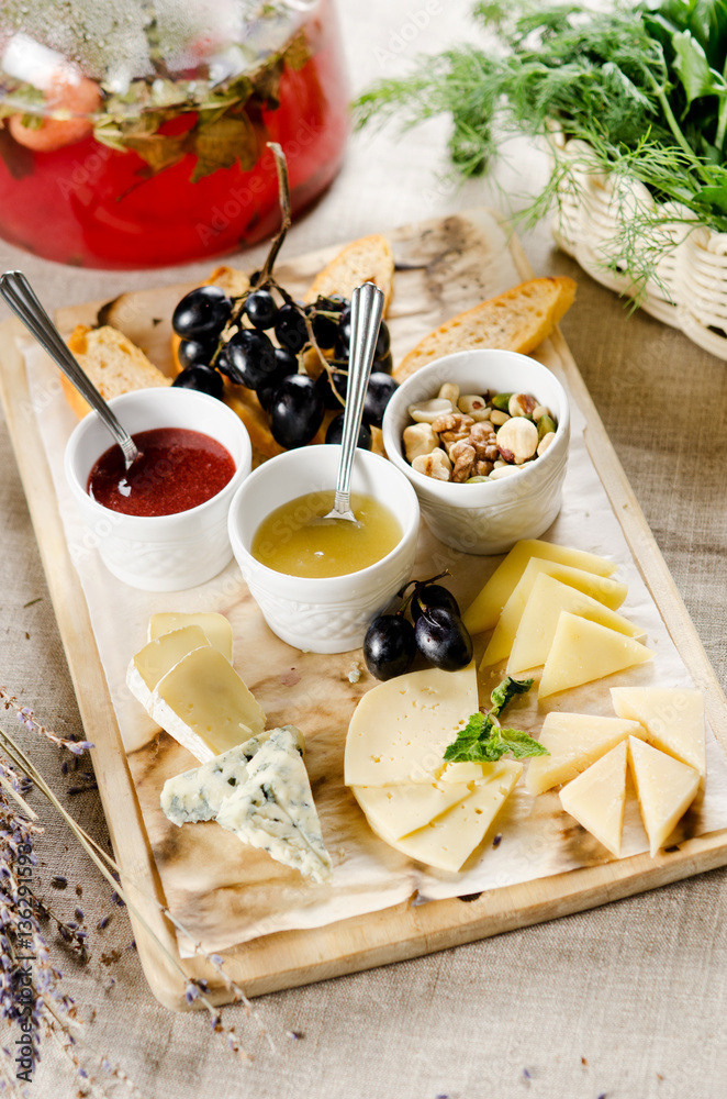 assorted cheeses with honey, jam, nuts and grapes assorted cheeses with honey, jam, nuts and grapes