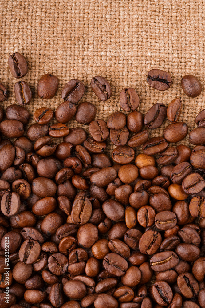 coffee beans on burlap background. roasted coffee beans isolated in white background. Roasted coffee beans background close up. Coffee beans pile from top on white background with copy space for text coffee beans on burlap background. roasted coffee beans isolated in white background. Roasted coffee beans background close up. Coffee beans pile from top on white background with copy space for text