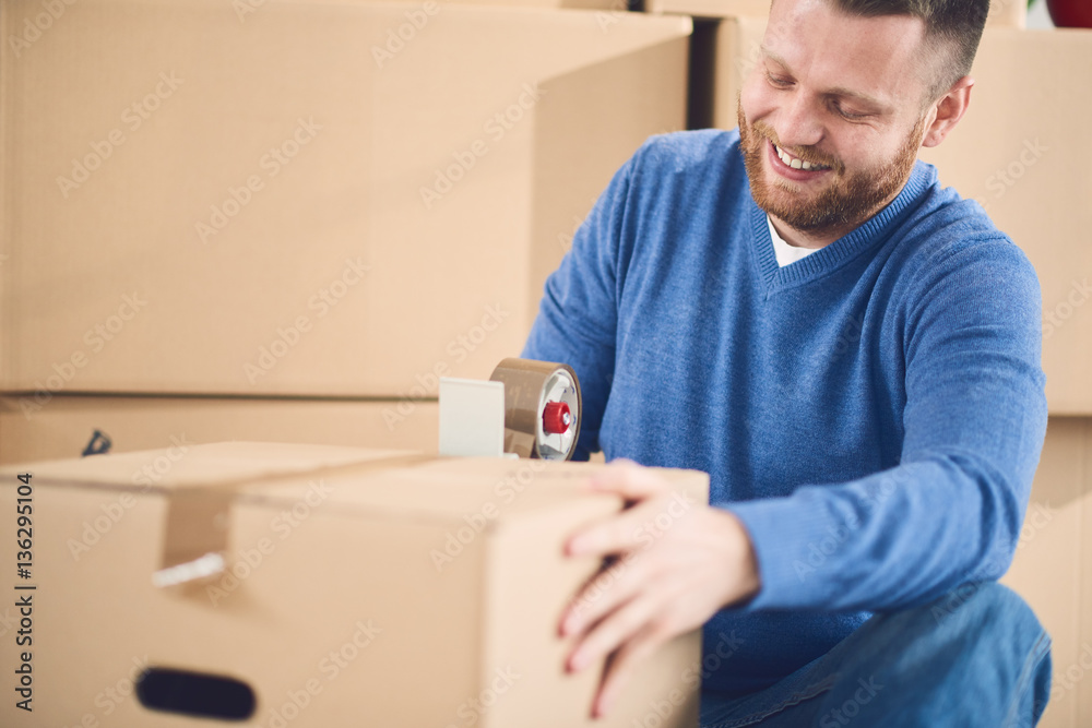 man moving in new apartment with many boxes with stuff