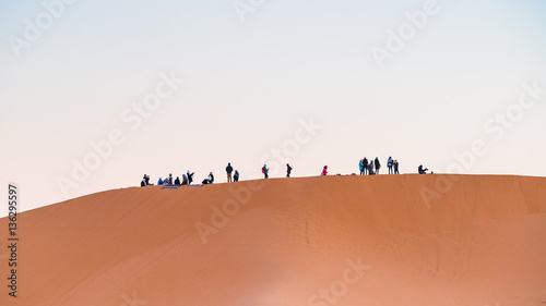 group of people in desert   © praphab144