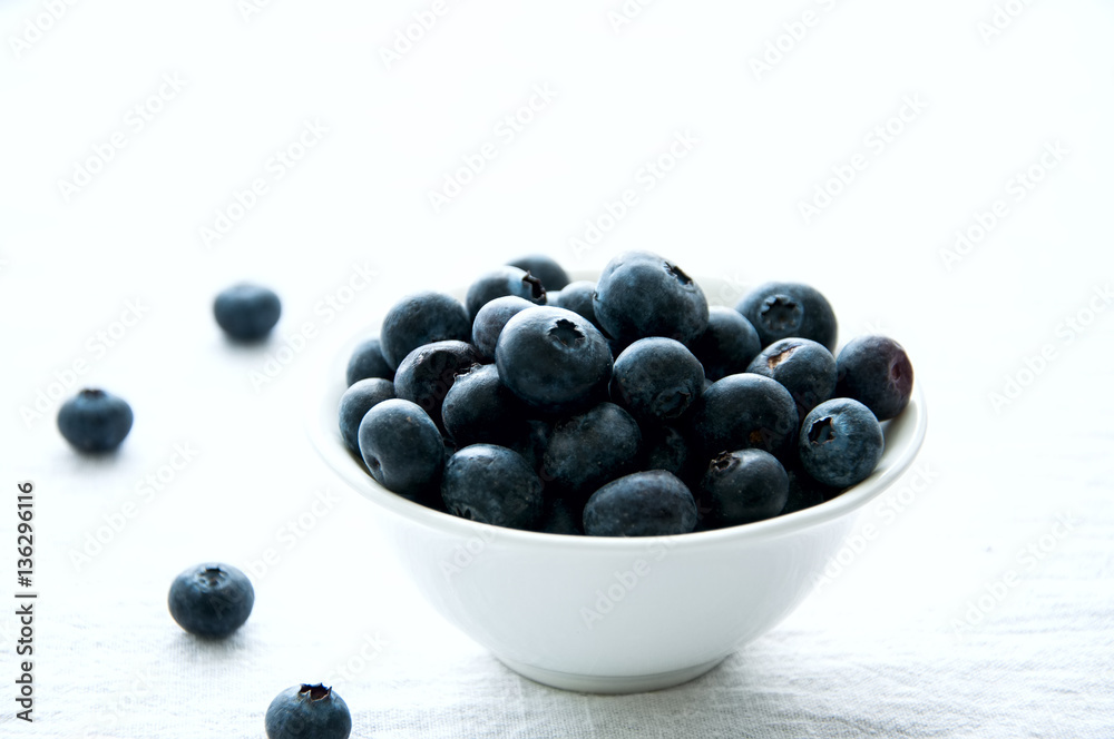 Blackberries in a white little bowl on a white background