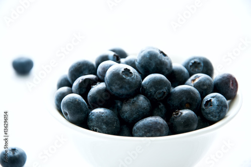 Blackberries in a white little bowl on a white background