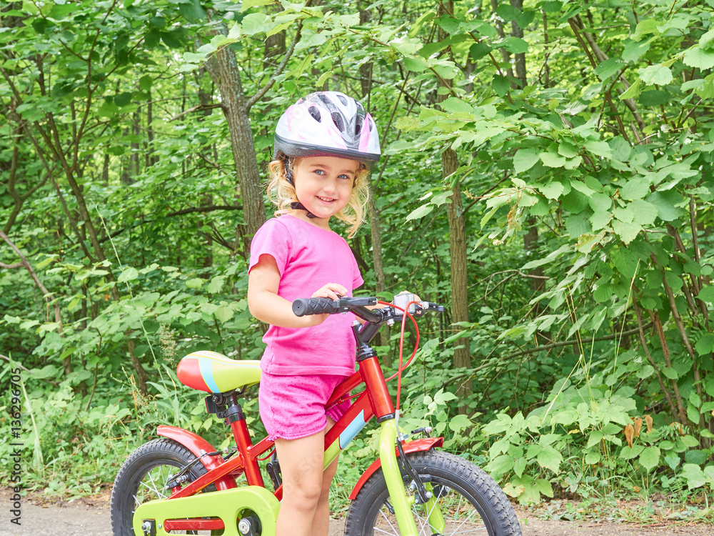 Happy child riding a bike in outdoor. Happy child riding a bike in outdoor.