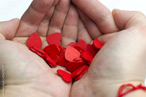 Hands holding a lot of hearts. photo