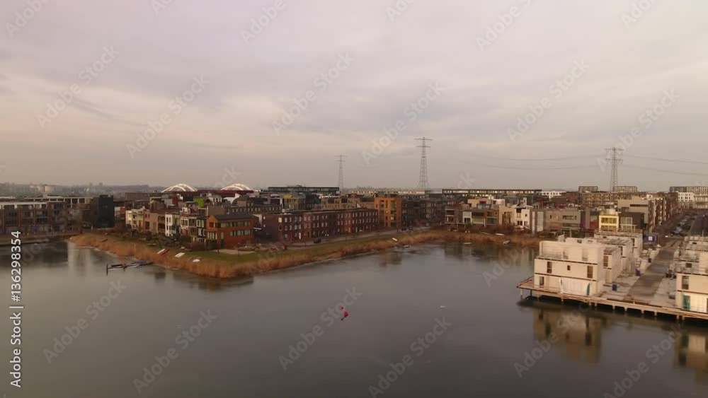 Urban development in Amsterdam of an area called IJburg, aerial. Waterfront houses are still under construction. Urban development in Amsterdam of an area called IJburg, aerial. Waterfront houses are still under construction.