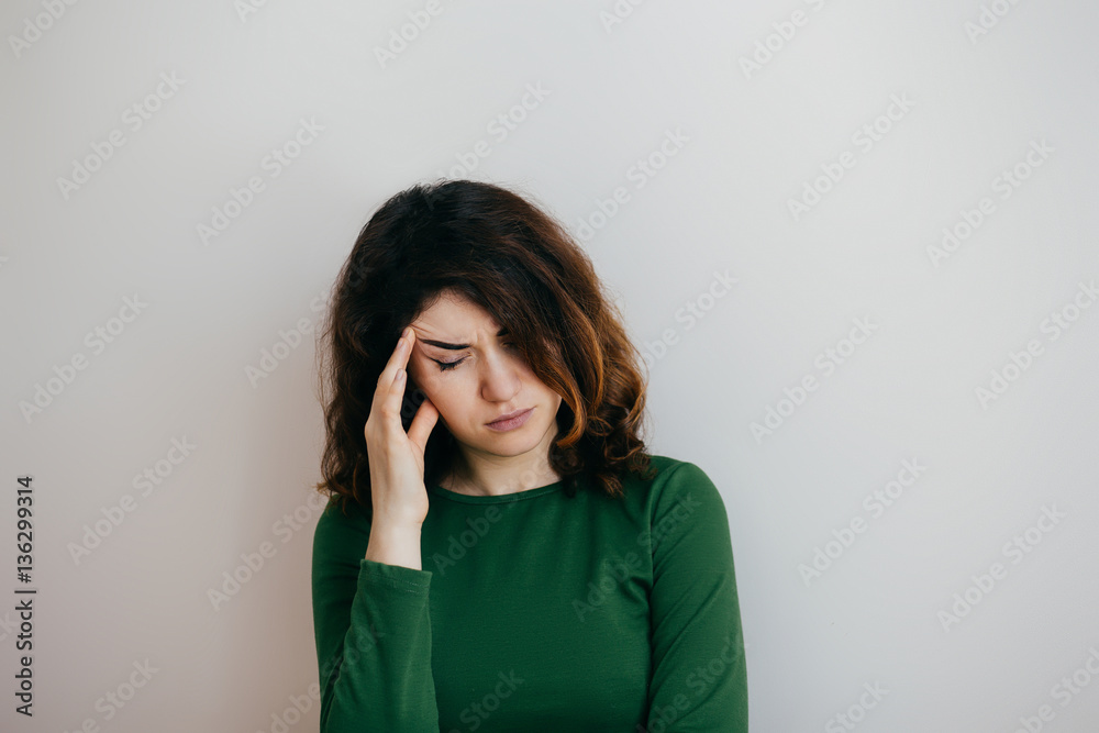 Young woman with headache, migraine, stress, insomnia, hangover on a light background
Young woman with headache, migraine, stress, insomnia, hangover on a light background