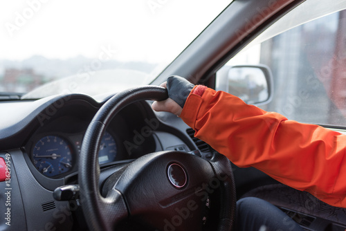 The young man behind the wheel of a car during a break between work