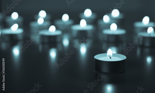 Flame of many candles burning on the background blue color