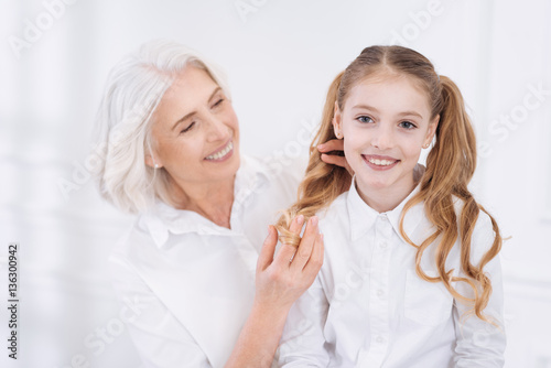 Positive senior woman resting with her granddaughter