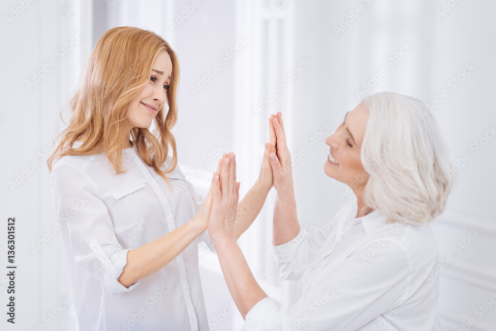 Positive mother and her adult daughter resting at home Positive mother and her adult daughter resting at home