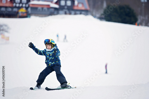 Cute child, skiing in the mountain