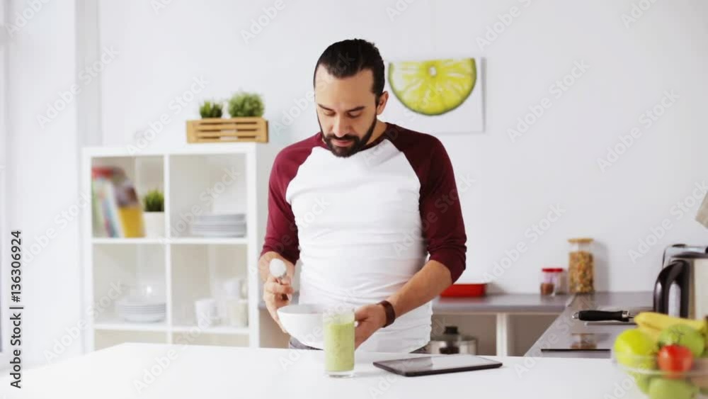 man with tablet pc eating breakfast at home man with tablet pc eating breakfast at home