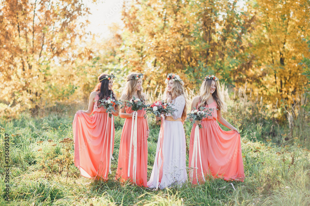 Bride with bridesmaids in pink dresses.