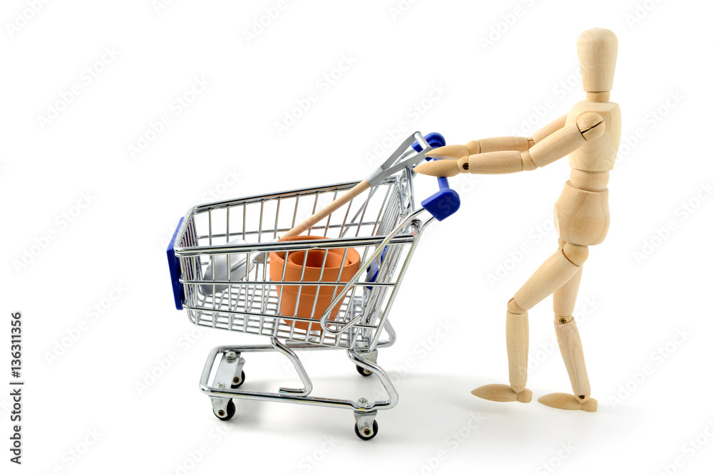 wooden mannequin shopping with a cart on white isolated backgrou wooden mannequin shopping with a cart on white isolated backgrou