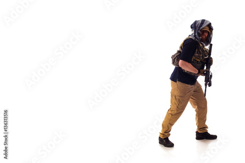 man in military outfit of the CIA, which is similar to the clothing of a warrior Mujahedin, in modern times on a white background in studio photo