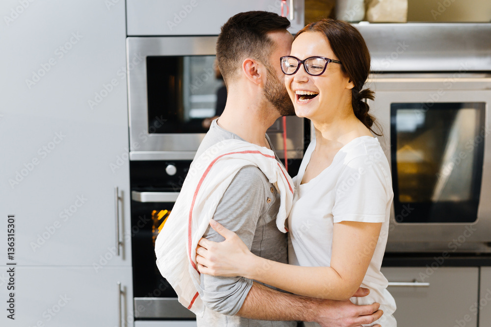 Affectionate spouses embracing at home