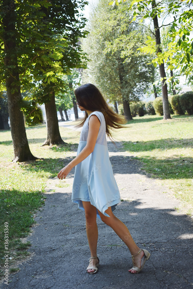 Beautiful smiling teenage girl in blue blouse, against green of Beautiful smiling teenage girl in blue blouse, against green of