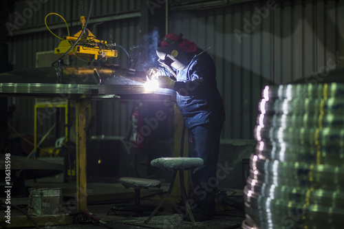 Man welding steel in factory