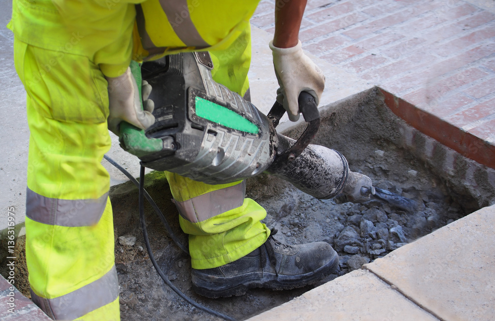 Fototapeta premium A man with a pavement saw