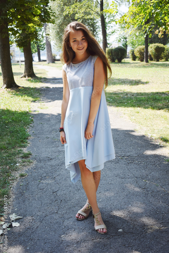 Portrait of beautiful teenage girl in blue blouse, against green Portrait of beautiful teenage girl in blue blouse, against green