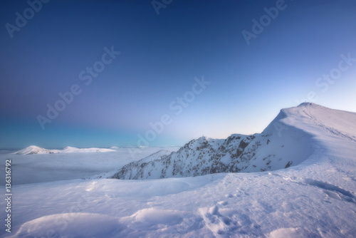 Mountain range above the clouds in the evening Twilight © masik0553
